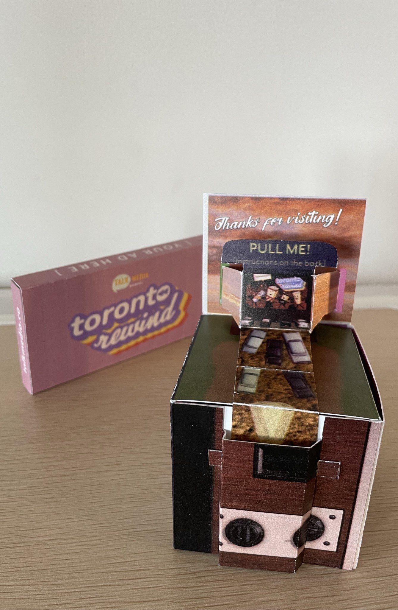 The design for our trial event included a pull-out drive-in feature which connected to a postcard flap to complete the top scene. Due to its intricacy, we removed this for the final event.